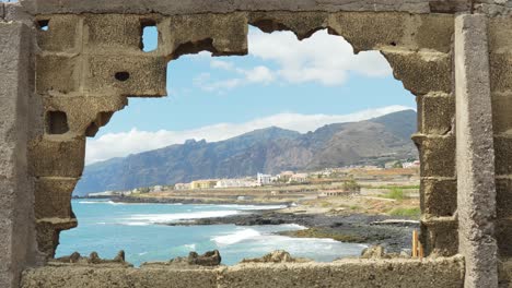 Broken-stone-wall-and-small-town-of-Tenerife-island-in-horizon