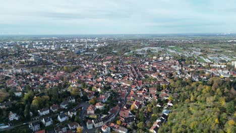 Aerial-drone-shot-of-Heidelberg-and-Handschuhsheim,-flying-above-town-looking-pull-away-shot-featuring-agricultural-and-farming-area