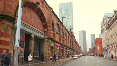 A-street-in-Manchester-with-goods-depots,-skyscrapers-in-the-background
