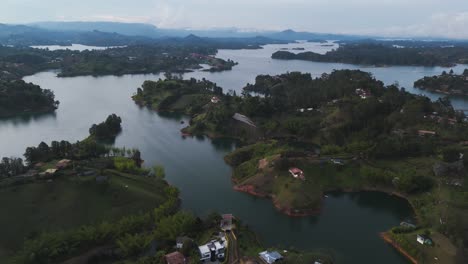 Establishing-Aerial-Landscape-of-Guatape,-Colombia-at-Sunset