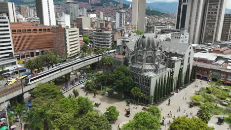 Establishing-Aerial-of-Downtown-Medellin-City-Buildings-and-Trains