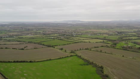 Lush-green-agriculture-fields-lined-by-trees-with-Dublin-City-Centre-in-the-distance