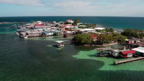 Panoramic-Drone-Aerial-Sea-Landscape-of-Utila-Bay-Honduras-Caribbean-Islands,-Small-Village-around-Natural-Water-Paradise