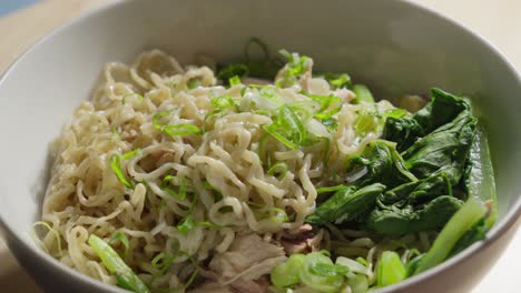 Scallion-or-green-onions-drizzled-on-top-of-Bakmi-wheat-based-Chinese-style-noodles