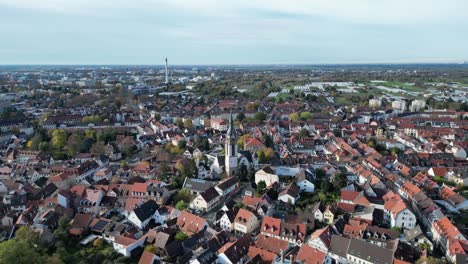 Aerial-drone-shot-of-Handschuhsheim,-flying-above-town-orbiting-around-Friedenskirche-church