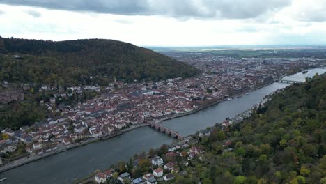 High-wide-angle-drone-shot-of-Heidelberg,-shot-from-above-autumn-forest