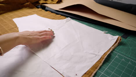 Seamstress-pinning-sewing-templates-to-cloth