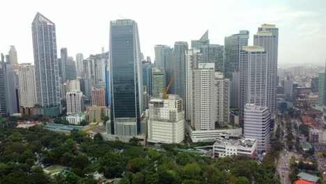 Modern-skyline-surrounded-by-trees-in-Makati-city,-Philippines