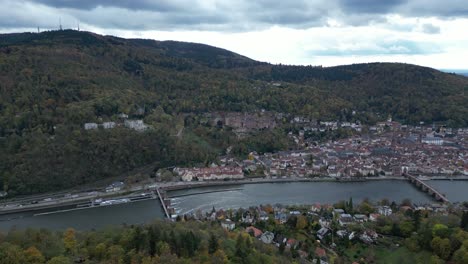 Push-in-drone-shot-of-Heidelberg,-shot-from-above-autumn-forest
