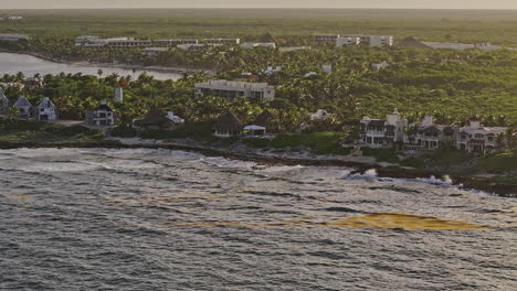 Akumal-Mexico-Aerial-v1-cinematic-drone-flyover-the-coastline-capturing-upscale-seafront-homes-and-vacation-resorts-and-Mayan-jungle-landscape-views-at-sunset---Shot-with-Mavic-3-Pro-Cine---July-2023