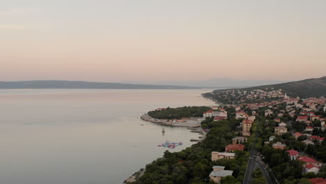 The-quiet-coastline-of-Novi-Vinodolski-in-Croatia-during-sunrise,-breathtaking-sea-view,-golden-hour,-early-morning-view-of-the-calm-Adriatic-sea,-tourism,-travel-destination,-summer-holiday-adventure