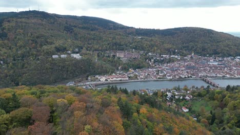 Pull-away-drone-shot-of-Heidelberg,-shot-from-above-forest