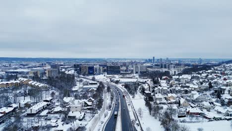Panoramic-aerial-establish-of-snow-covered-city,-Vilnius-Lithuania