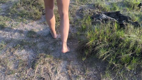 Walking-barefoot-between-sand-and-rocks-on-a-wild-island