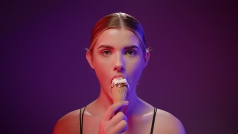 Caucasian-woman-with-studio-background-eats-an-ice-cream-suggestively-close-shot