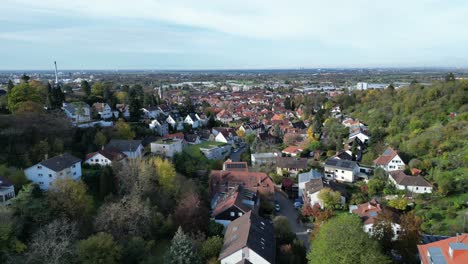 Low-angle-Drone-shot-of-Handschuhsheim,-flying-above-town-push-in-towards-Friedenskirche-church