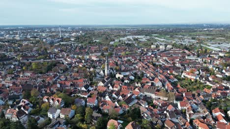 High-angle-drone-shot-of-Handschuhsheim,-flying-above-town-orbiting-around-Friedenskirche-church
