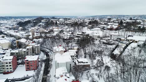 Neighborhood-buildings-up-on-Kaunas-Lithuania-snow-covered-trees-without-leaves