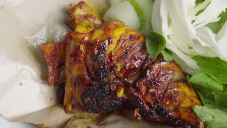 Indonesian-grilled-chicken-with-perfect-char-on-bed-of-cabbage-and-basil-mint-leaves,-ayam-bakar
