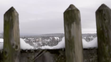 Slowly-Lifting-Above-Fence-to-Reveal-Vast-White-Snowy-Landscape