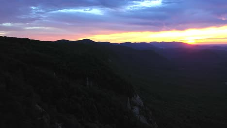 Vivid-Sunrise-over-Mountains-near-Pretty-Place-Chapel,-Cinematic-Drone,-Fred-W