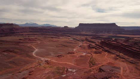 Drone-aerial-view-of-red-rock-canyons-and-mountains-in-Moab,-Utah