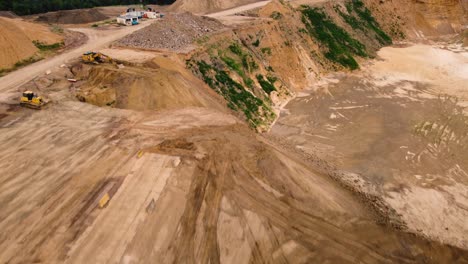 Excavation-machines-working-in-massive-quarry,-aerial-view