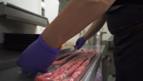 Butcher-making-long-delicious-and-fresh-sausages,-close-up
