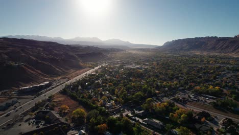 Drone-shot-panning-to-the-left-of-Moab,-Utah-at-sunrise