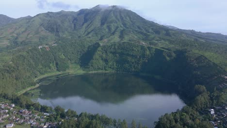 Aerial-view-of-crater-lake-on-the-mountain-with-forest-vegetation