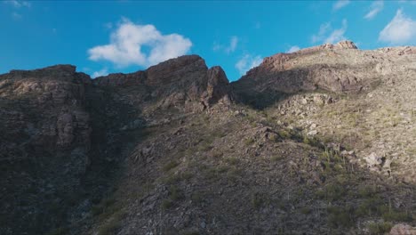 Slow-Dramatic-Aerial-Footage-of-Desert-Mountain-with-Vibrant-Blue-Sky-in-Background-in-Tucson-Arizona