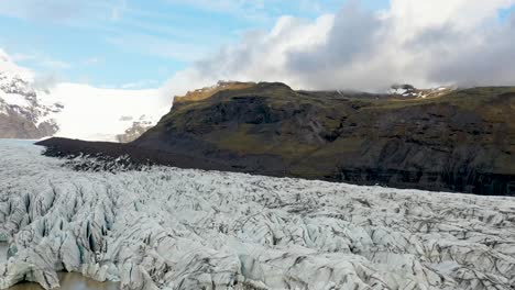 Flyover-drone-shot-on-Svinafellsjokull-glacier-outlet-in-Vatnajokull-National-Park-in-South-Iceland