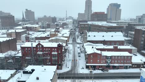 Aerial-reveal-of-American-city-covered-in-snow