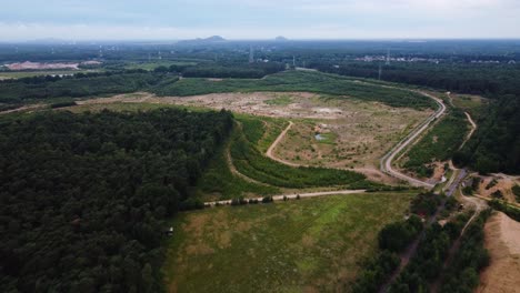 Area-prepared-for-quarry-excavation-surrounded-by-woodland,-aerial-view