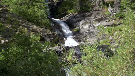 Right-Twin-Falls-waterfall-at-Two-Medicine-Lake-in-Glacier-National-Park,-Tilt-Down