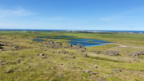 Hvalfjarðarsveit-flat-inland-grassland-landscape-with-pools-on-Iceland-nature-reserve