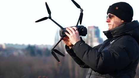 Person-hold-drone-sideways-and-rotate-around-it-axis-to-calibrate-system