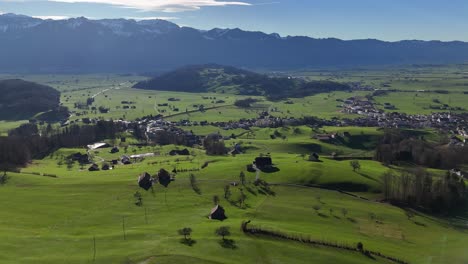 Aerial-of-small-village-in-Swiss-Alps-with-mountainous-background---Rieden,-Switzerland