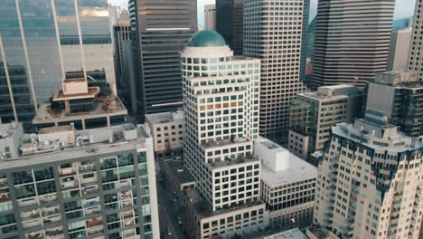 Aerial-ascending-retreat-from-brown-and-silver-modern-buildings-in-downtown-Seattle
