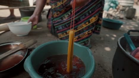 Woman-Soaking-Threads-Into-Basin-With-Dye-For-Mayan-Textiles