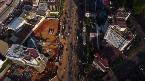 Aerial-tilt-shot-following-cars-in-downtown-Yaounde,-sunny-Cameroon,-Africa