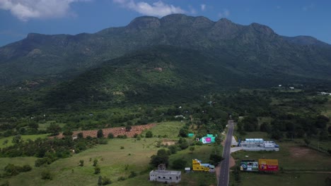 Scenic-National-Highway-in-the-Western-Ghats-with-mountains-and-coconut-farm-fields-in-view,-Tamil-Nadu,-India