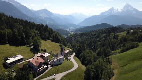 drone-shot-flying-over-Maria-Gern-church-in-Bavaria,-Southern-germany-revealing-the-watzmann-in-the-background