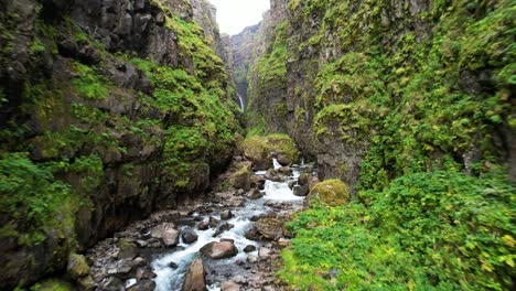 Glymur-waterfalls-aerial-view-flying-down-lush-Icelandic-valley-canyon-Iceland-extreme-terriain