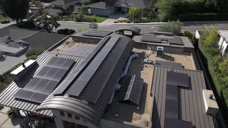 A-solar-panel-project-on-a-modern-building-in-Encino-Hills,-California,-on-a-sunny-day,-aerial-view