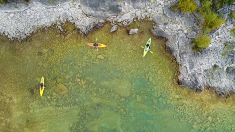 aerial-overhead-of-color-weekend-kayakers-enjoying-the-outdoors-paddling-through-clear-northern-waters