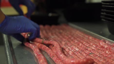Production-of-fresh-and-tasty-natural-sausages-by-butcher,-close-up