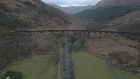 The-historic-glenfinnan-viaduct-in-scotland,-surrounded-by-nature,-aerial-view