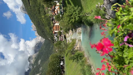 VERTICAL-establishing-river-summer-stream-in-the-picturesque-Italian-resort-town-of-Molveno