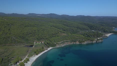 Cinematic-rotating-up-high-4K-drone-clip-over-the-tropical-blue-waters-of-Toroni-in-Chalkidiki